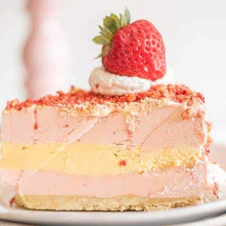 Single slice of strawberry shortcake ice cream cake on white plate