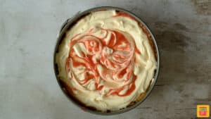 strawberry swirl cheesecake in the springform pan before baking