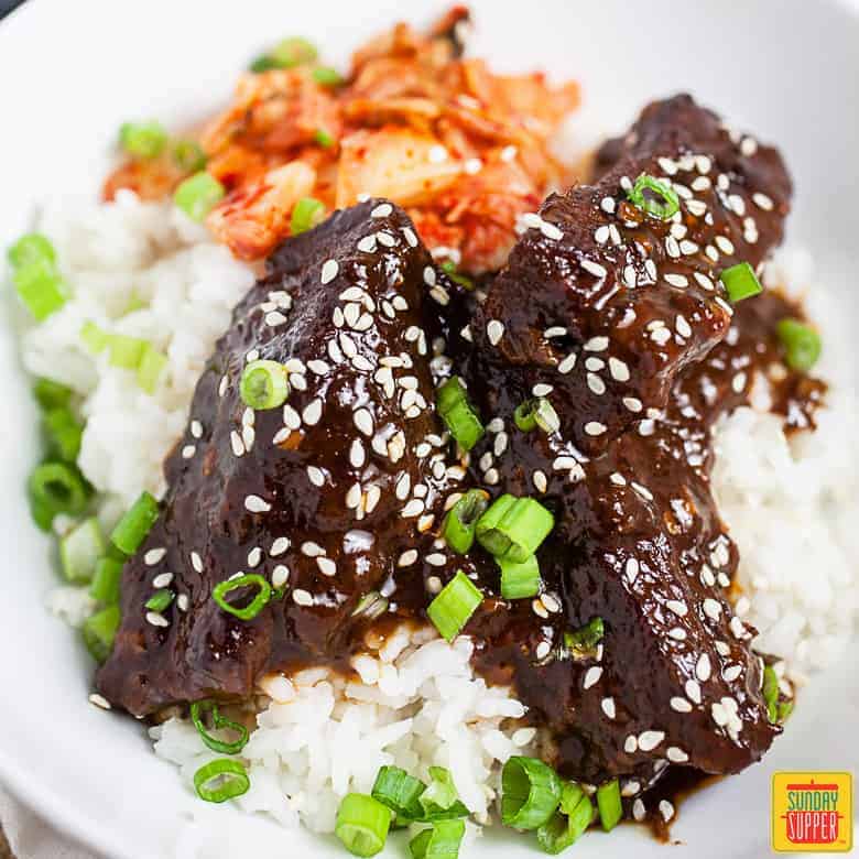 Korean braised short ribs (Galbi Jjim) over a bed of rice and kimchi