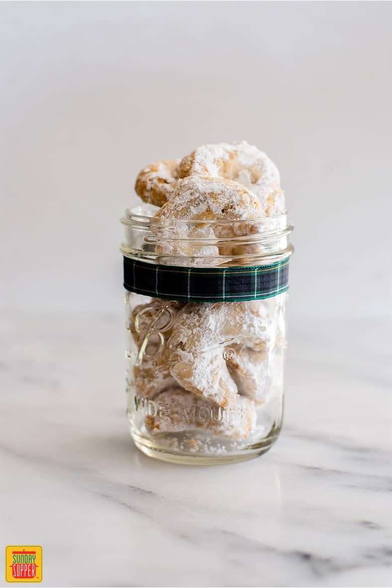 A jar of Kourabiedes with a festive ribbon