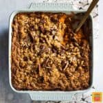 Southern Sweet Potato Casserole in a serving dish with a wooden spoon to dish some out