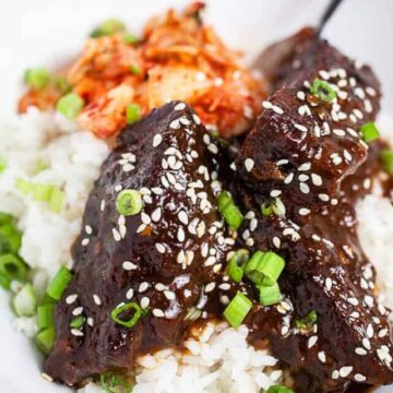 Korean braised short ribs over rice in a white dish