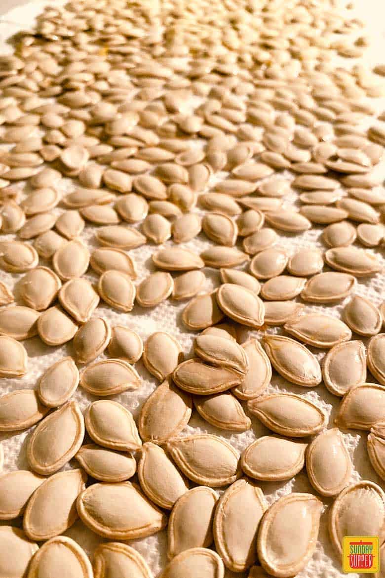 Raw pumpkin seeds on paper towel to dry