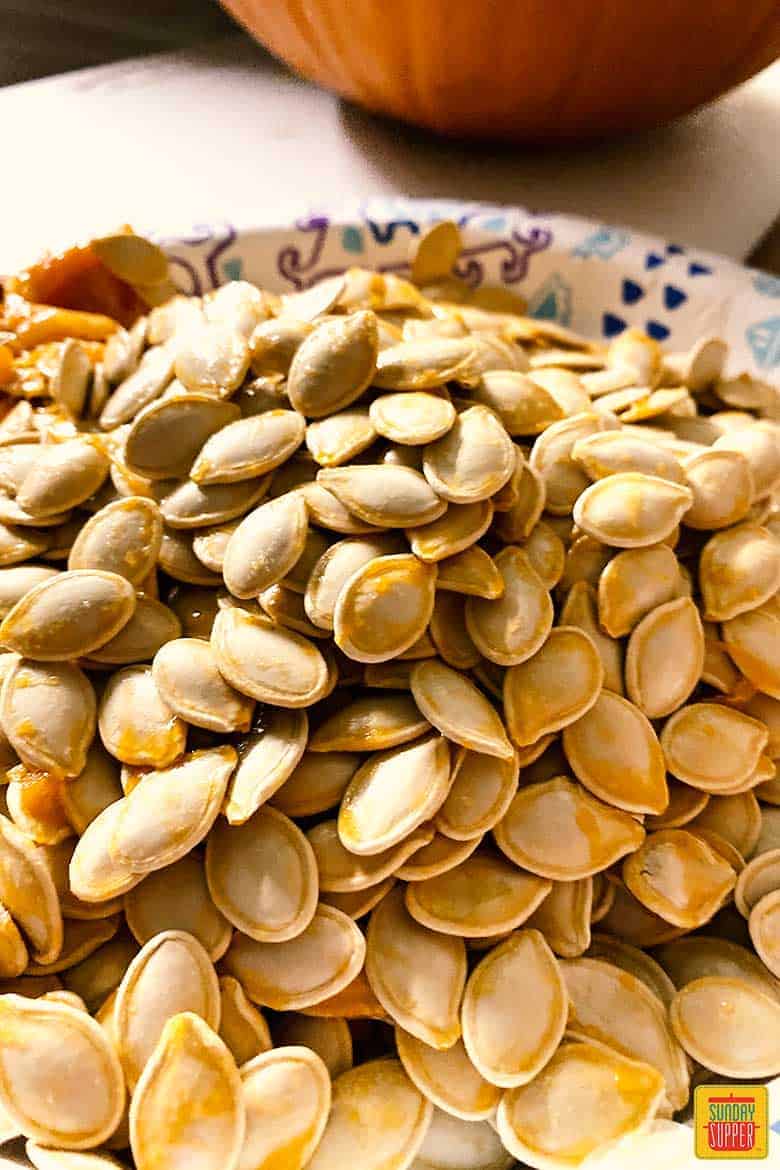 Cleaned pumpkin seeds on a paper plate