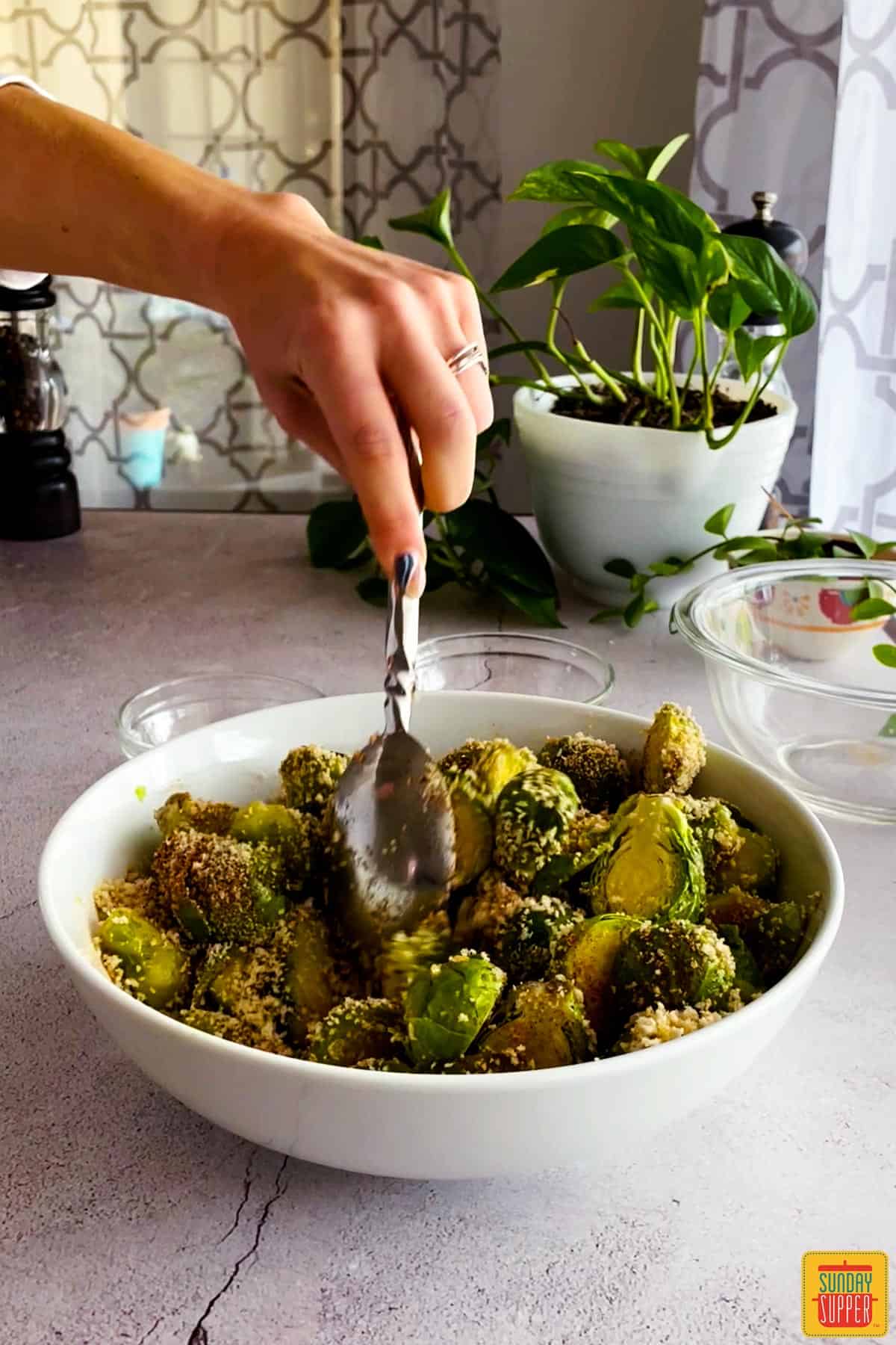 Brussels sprouts and breadcrumbs mixture mixed in a white bowl