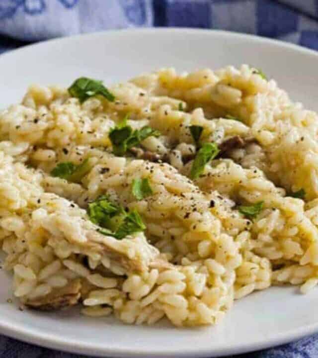Instant Pot Risotto with porcini mushrooms served on a plate with a blue napkin