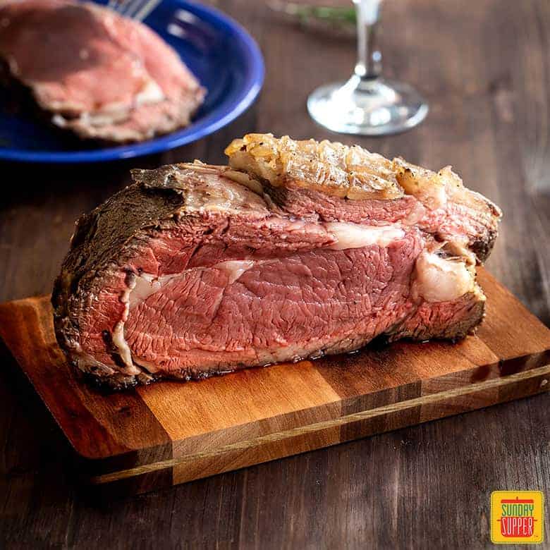 prime rib on a cutting board after cooking