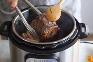 searing the rib roast on all sides in the instant pot