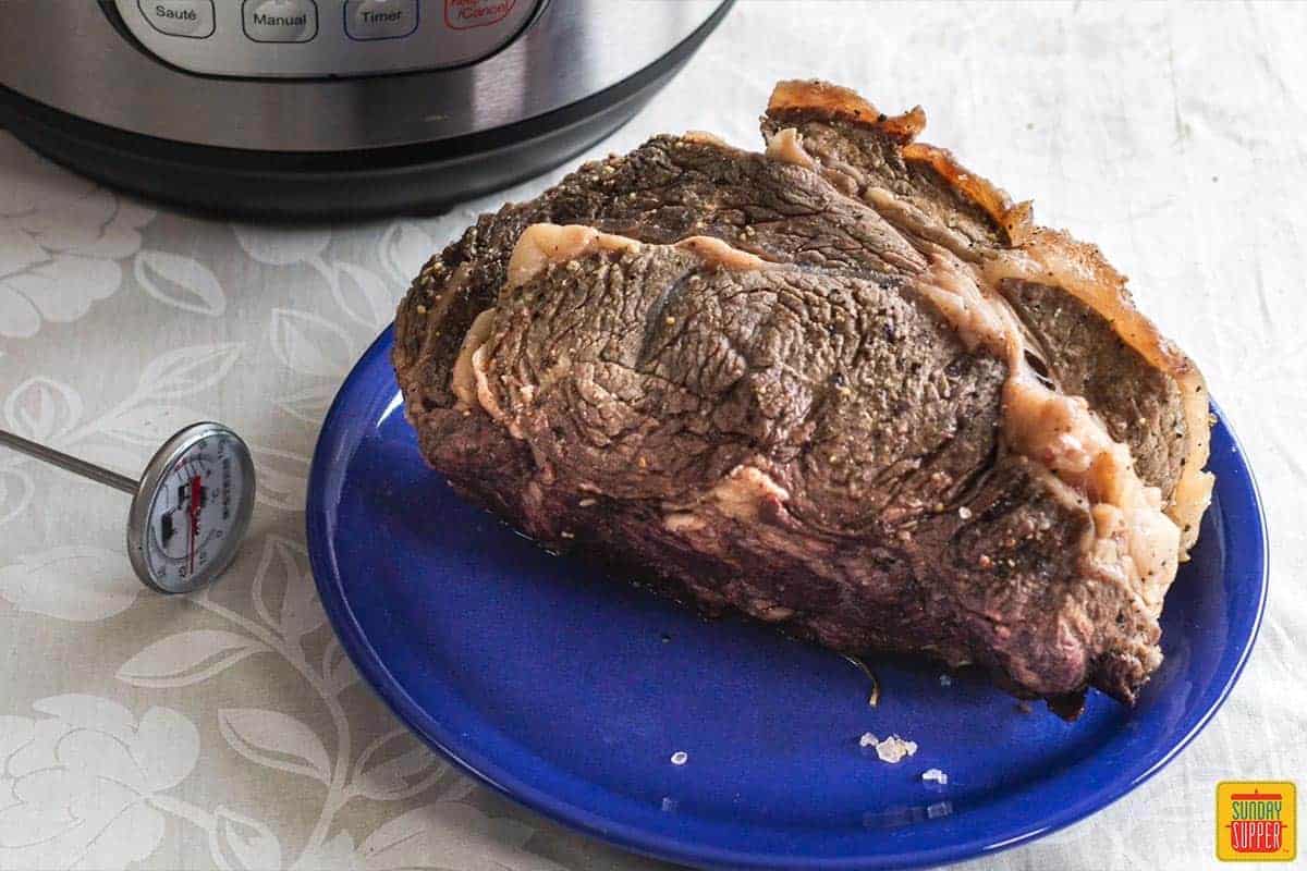 boneless rib roast on a blue plate