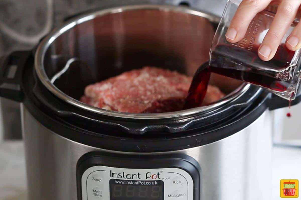 pouring red wine into the instant pot