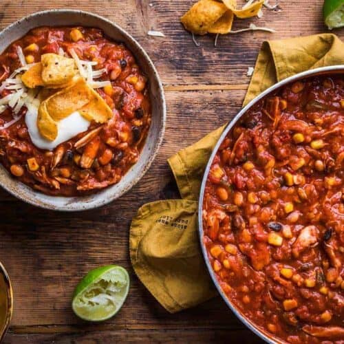 Bowl of the best chicken chili next to the pot of chili
