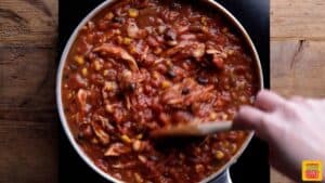 Stirring to combine best chicken chili recipe