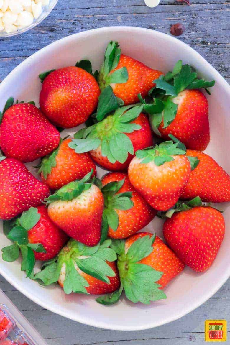 How to Make Chocolate Covered Strawberries: Fresh strawberries in a white bowl