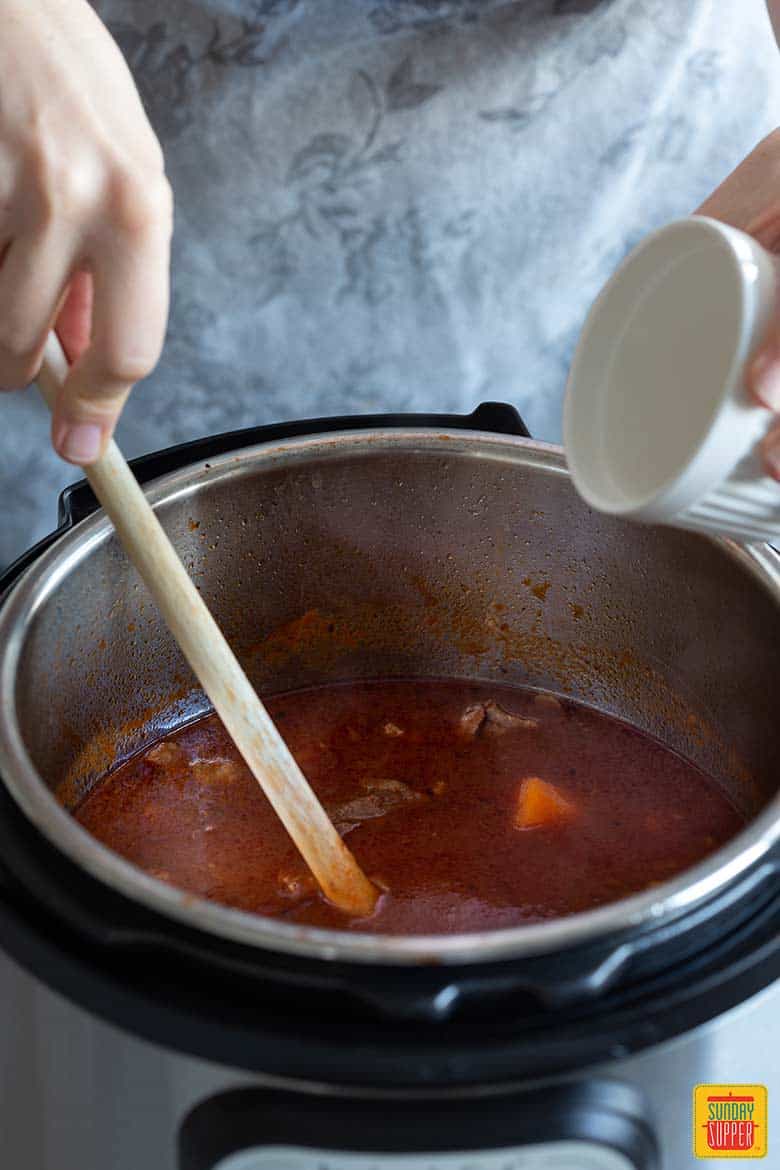 Stirring beef stew in instant pot