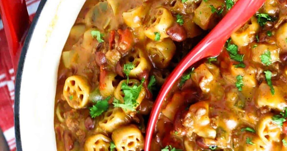 Chili mac recipe in a pot with a red ladle