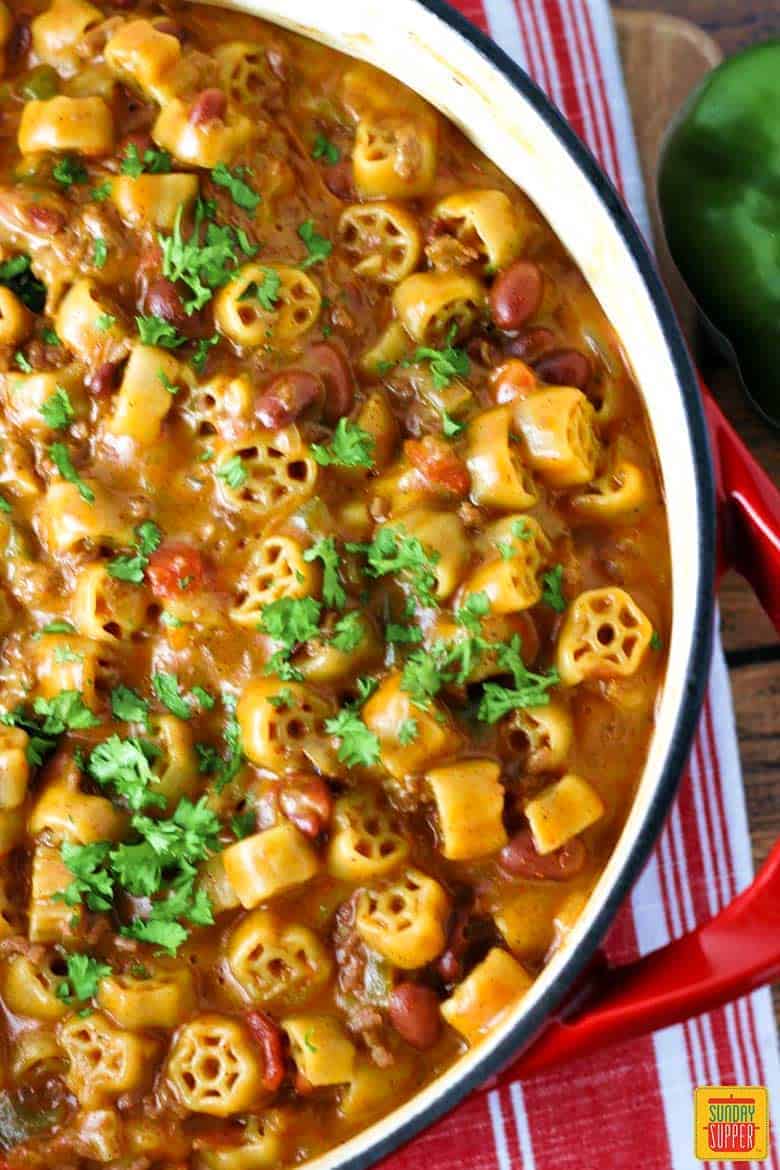 Chili mac recipe in a red and white skillet