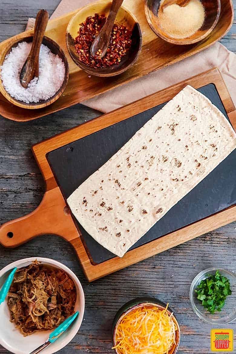 flatbread on serving board with flatbread recipe ingredients