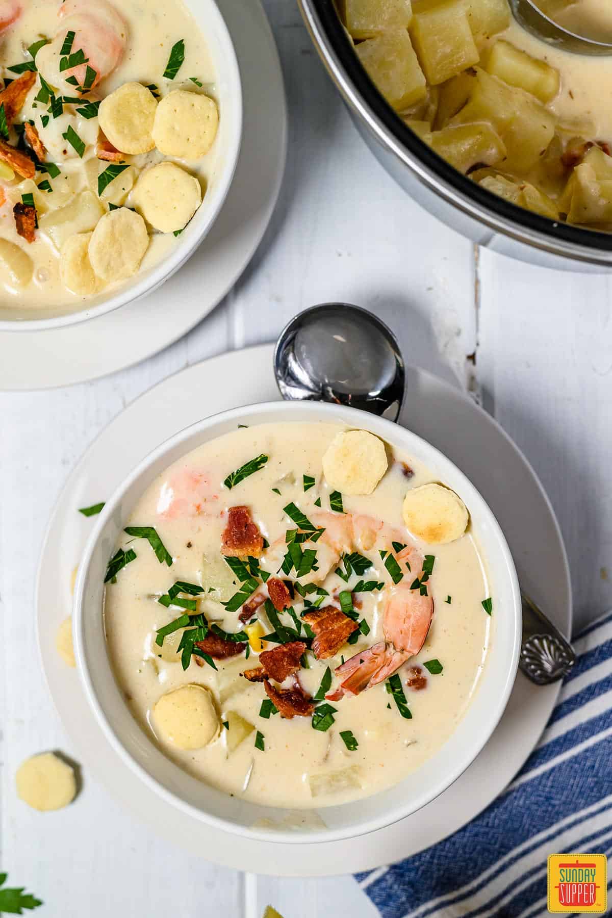 Overhead shot of a bowl of seafood chowder with a spoon