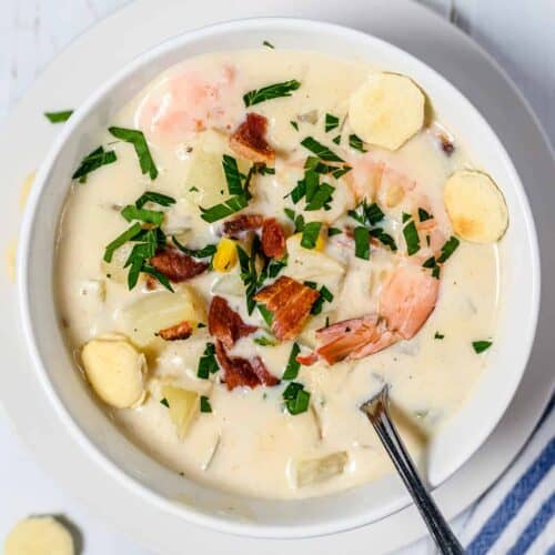 Overhead shot of a bowl of seafood chowder with a spoon