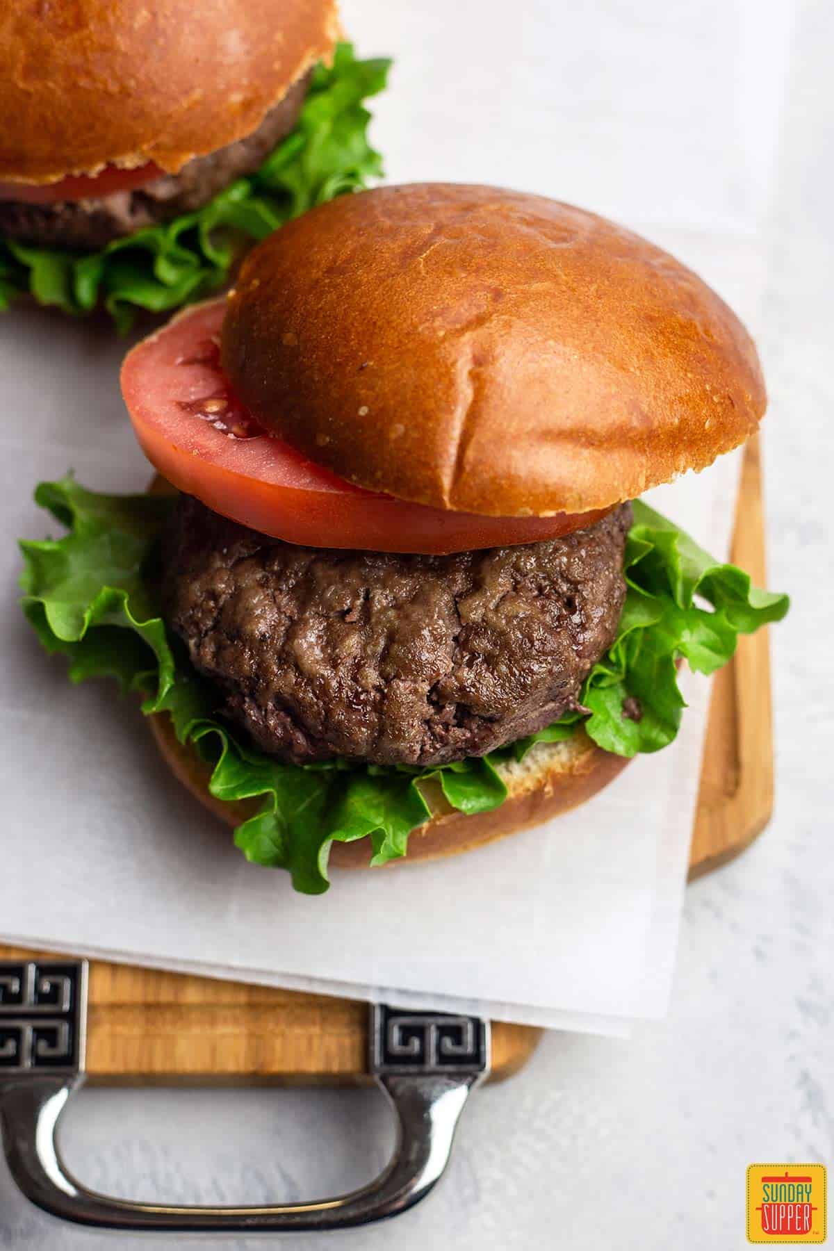 An air fryer hamburger with the top bun moved aside to show the burger