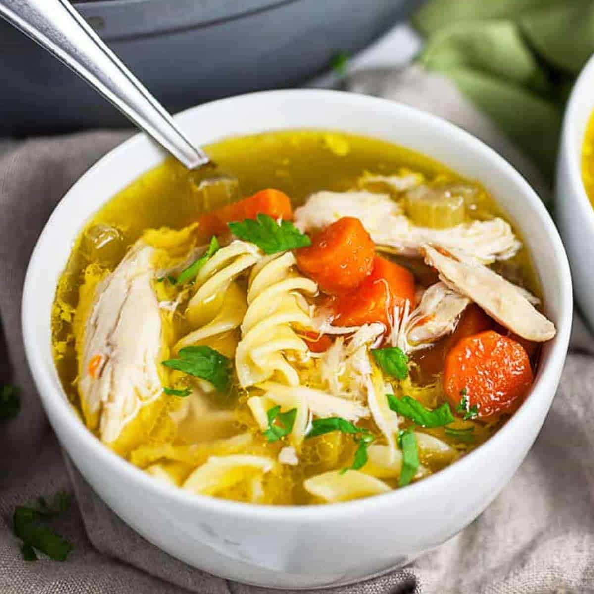 Chick-fil-A chicken noodle soup in a bowl with a spoon