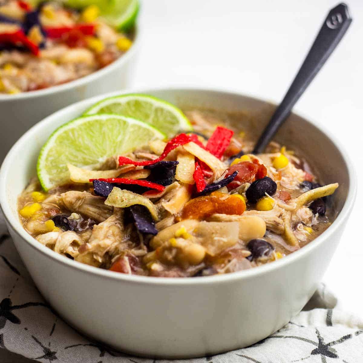 Close up of a bowl of chick-fil-a chicken tortilla soup with fresh limes