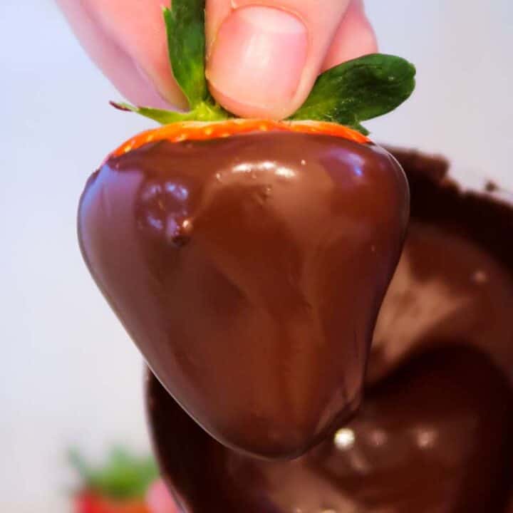 How to make chocolate covered strawberries: chocolate covered strawberry in hand