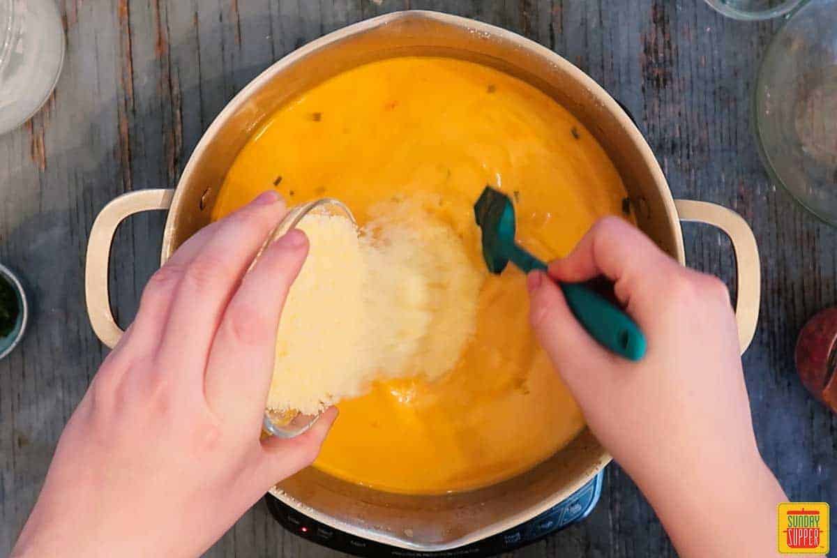 Pouring Parmesan cheese into the pot