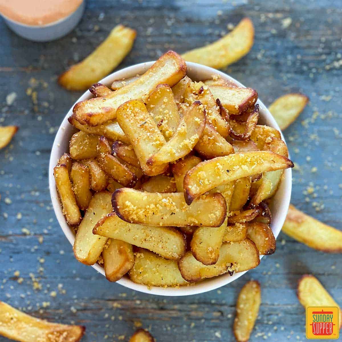 White bowl of air fryer frozen French fries