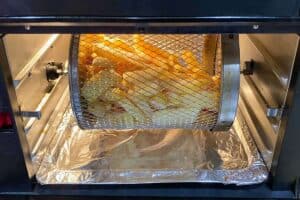Frozen french fries cooking in the air fryer