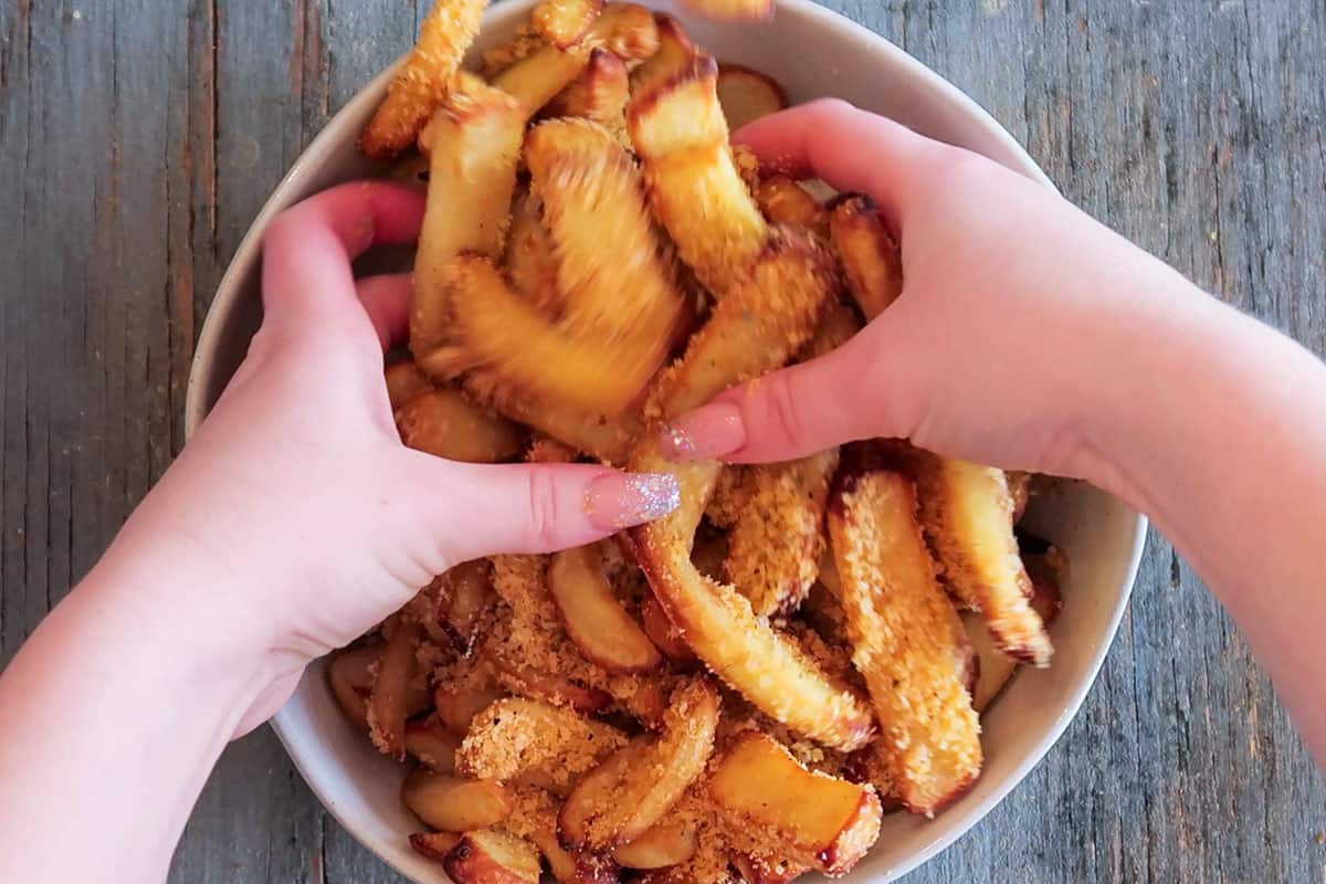 Tossing french fries in seasoning
