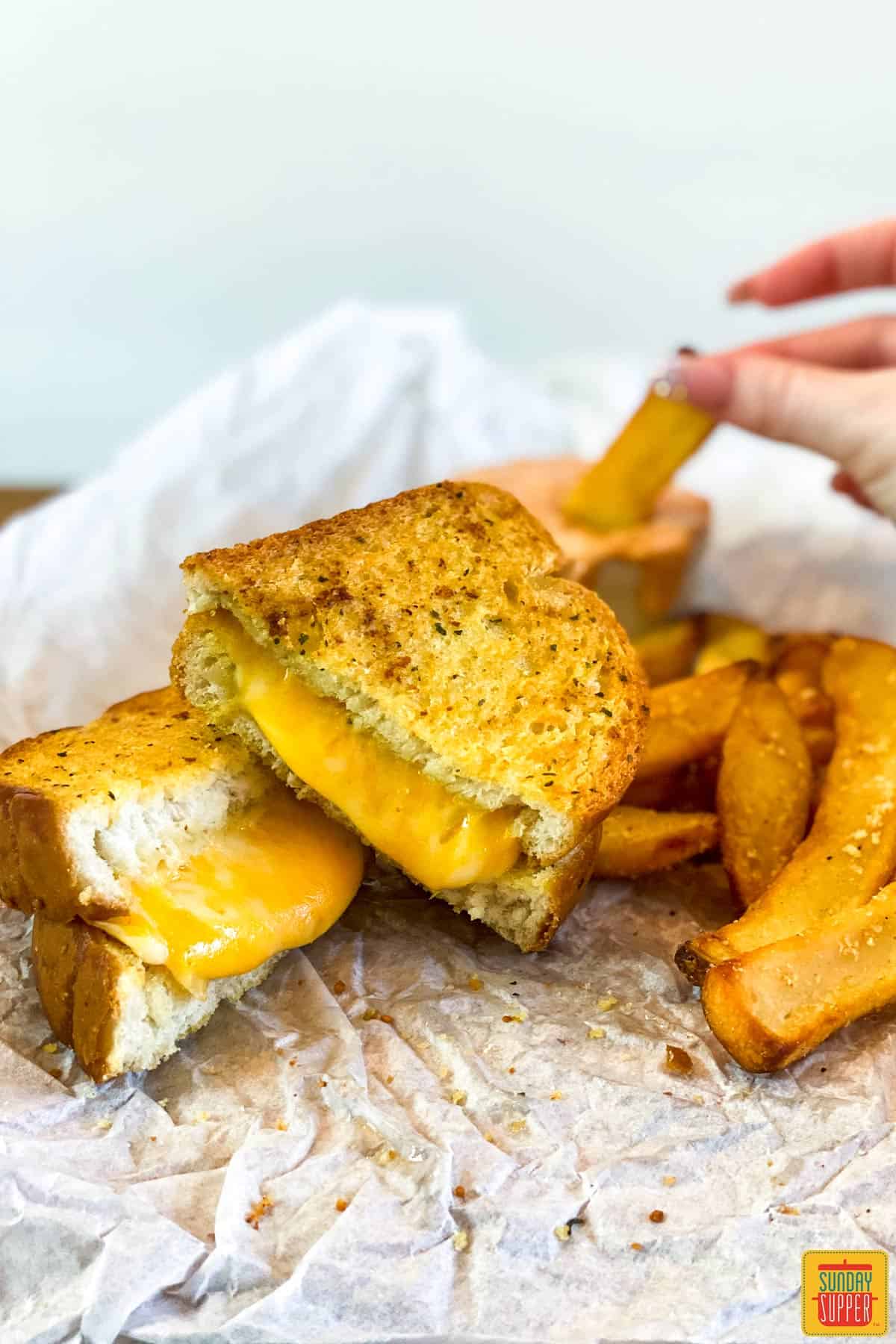 Dipping a fry behind air fryer grilled cheese