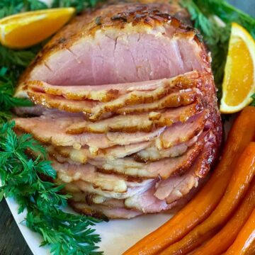 Close up of air fryer ham with citrus and candied carrots