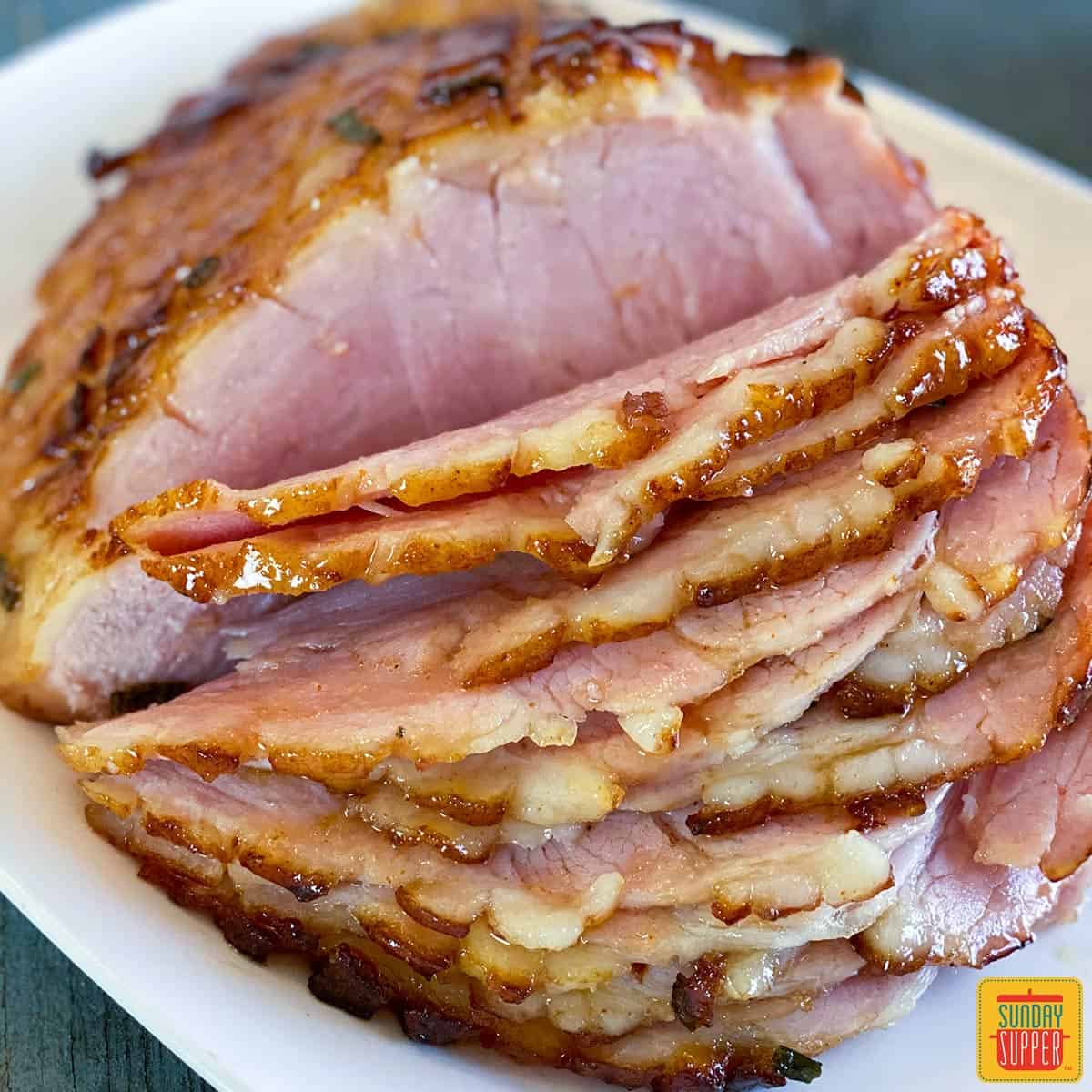 Air fryer ham sliced on a white platter