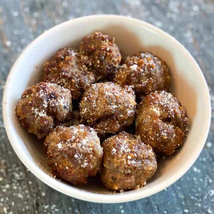 Eight meatballs in a white bowl