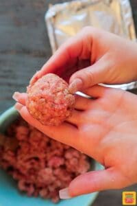 Rolling a meatball into a ball