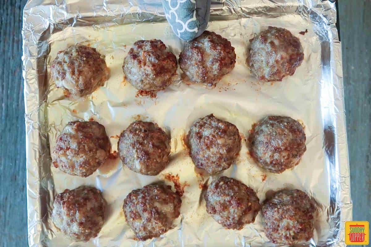 Cooked Air fryer meatballs on air fryer tray