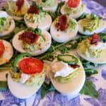 Close up of avocado deviled eggs on a white and blue floral plate