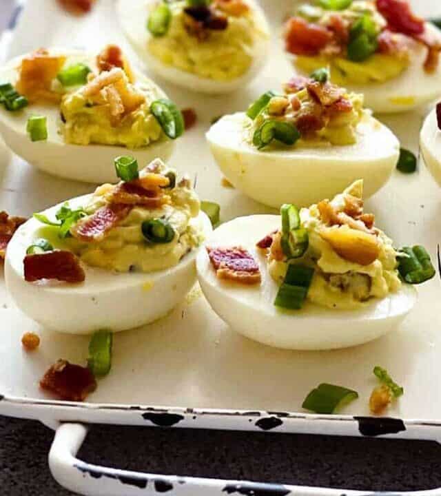 jalapeno popper deviled eggs on a white tray