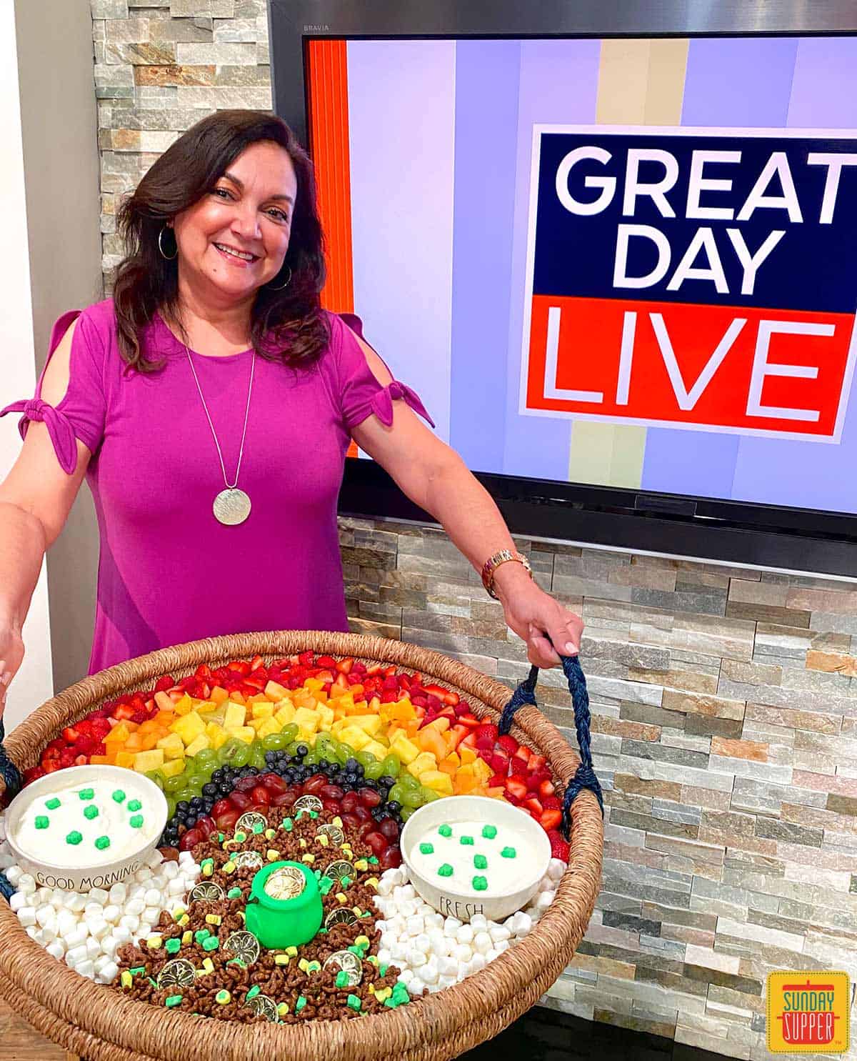 Isabel, Family Foodie, holding the fruit and yogurt parfait bar tray in front of the Great Day Live Tampa Bay set