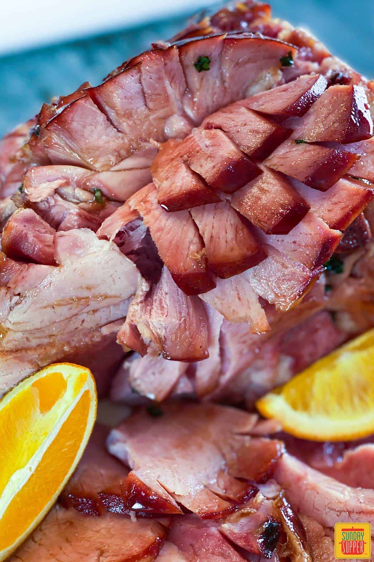 Slices of ham with orange wedges