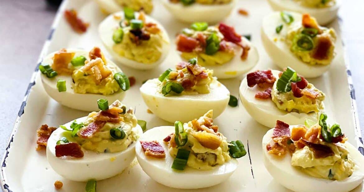jalapeno popper deviled eggs on a white tray