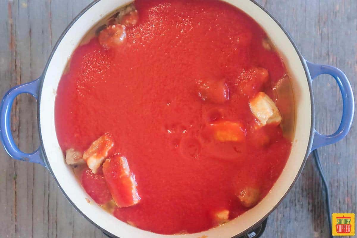 Adding tomato sauce to make meatball sauce recipe