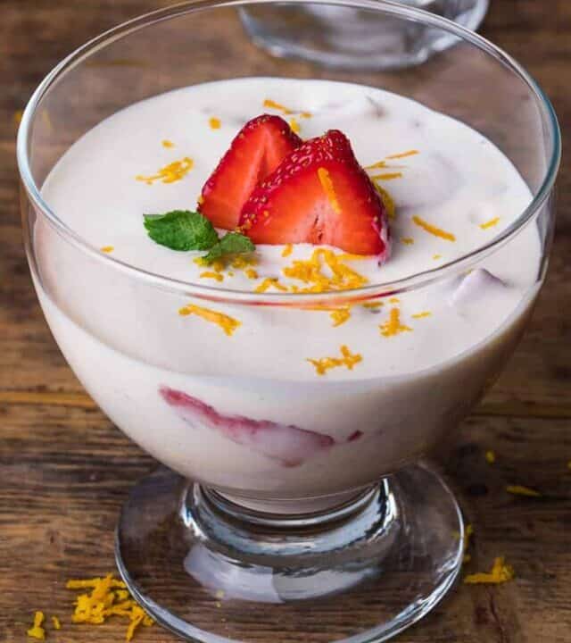 Fresas con Crema recipe in a bowl with sliced strawberries and orange zest