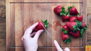 Slicing strawberries for Mexican strawberries and cream