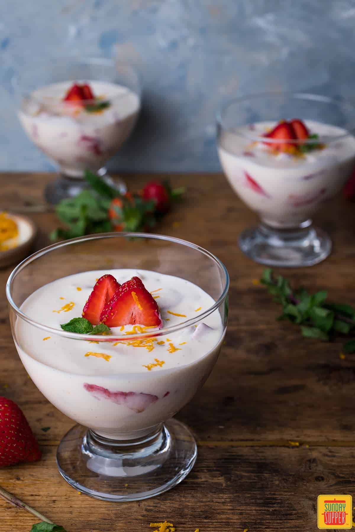 Fresas con Crema recipe divided into three bowls with fresh strawberries