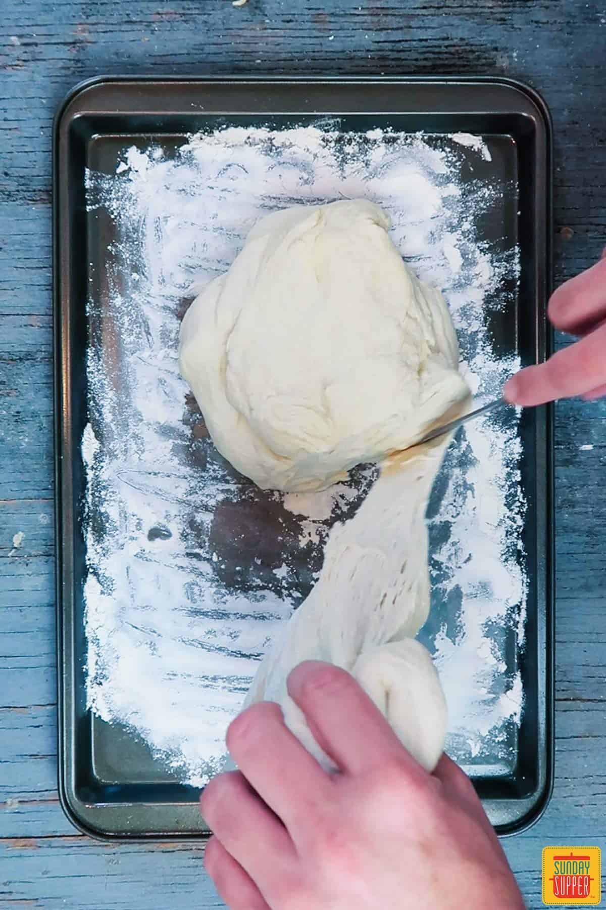 Cutting the dough in half for instant pot bread recipe