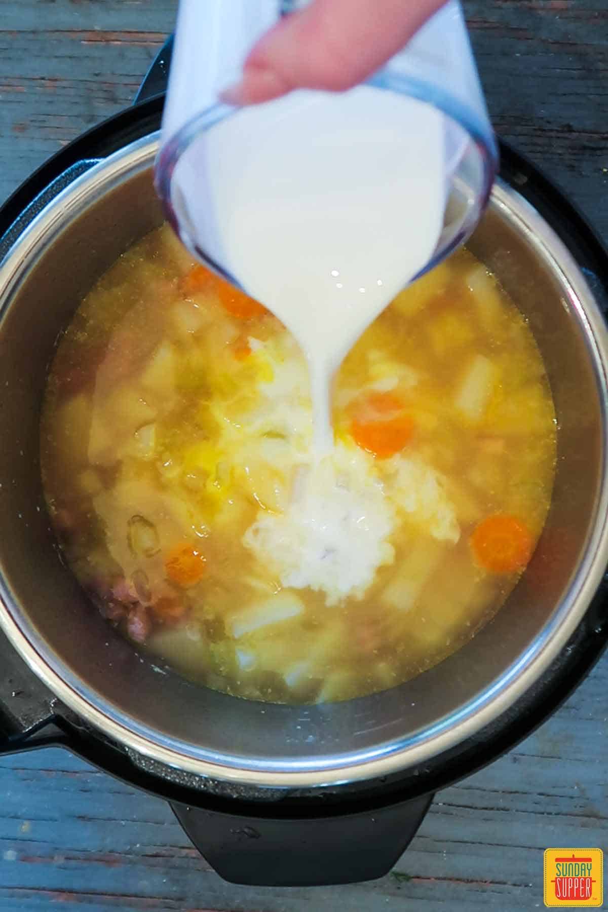 Pouring cream into the leftover ham soup