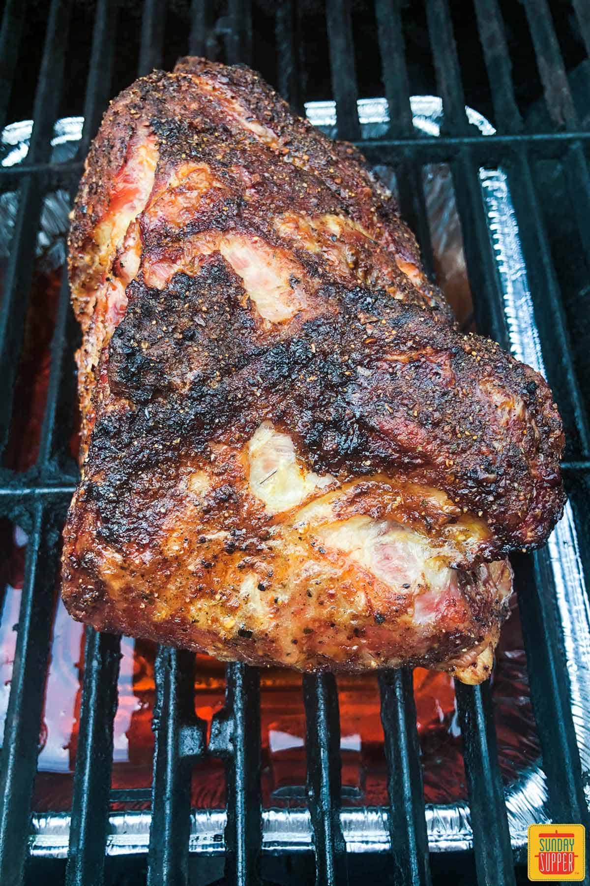 Grilled pork butt on the grill after cooking