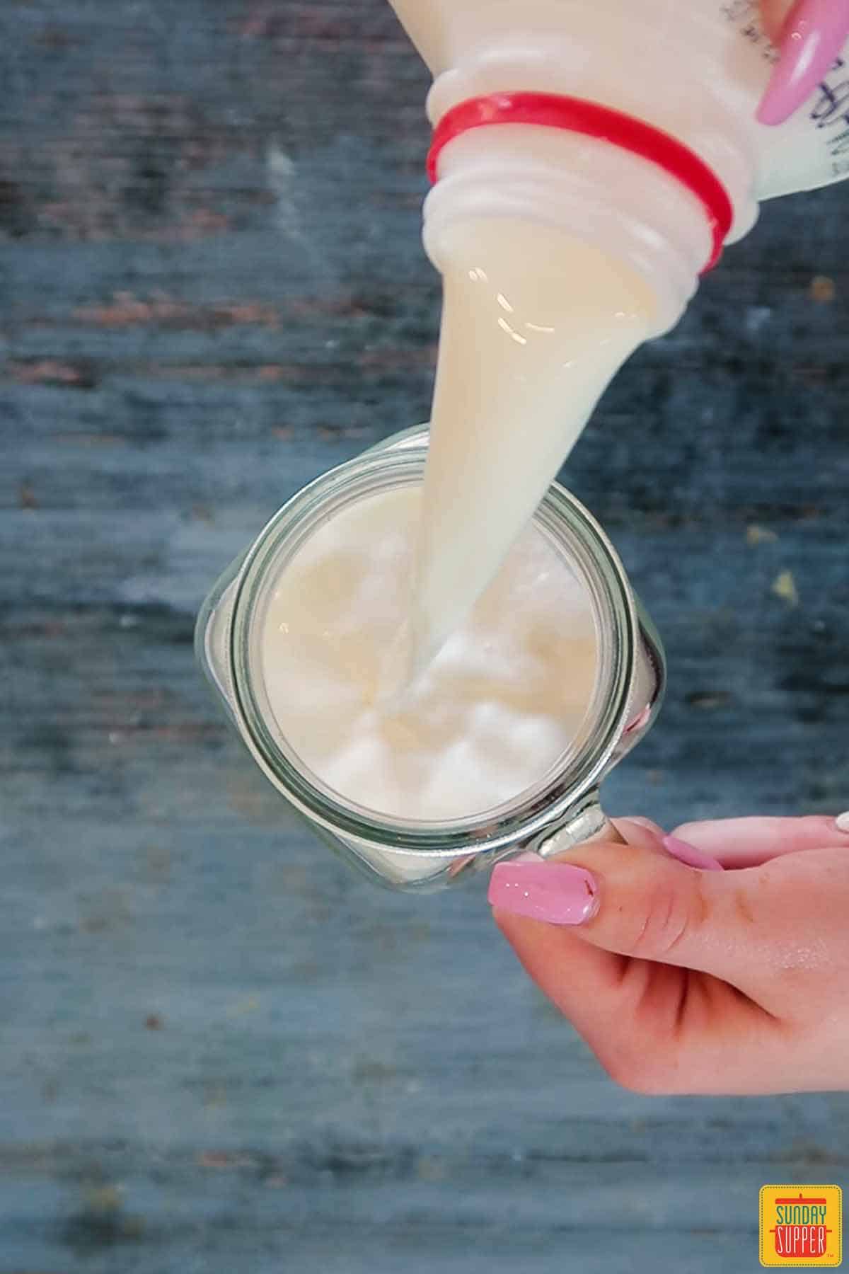 Pouring milk in a jar